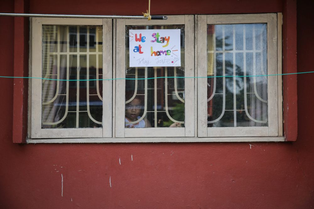 A sign reading u00e2u20acu02dcWe Stay at Home, Stay Safeu00e2u20acu2122 is seen on the window of a home during the movement control order in Shah Alam April 7, 2020. u00e2u20acu201d Picture by Yusof Mat Isa