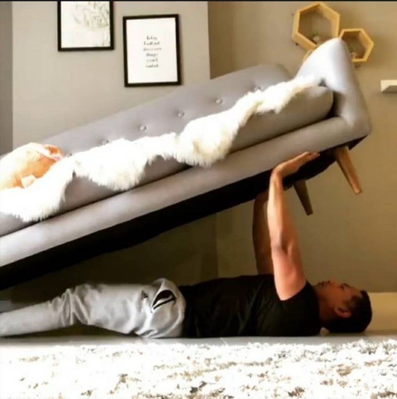 A man uses a sofa as weights. u00e2u20acu201d Twitter screencap