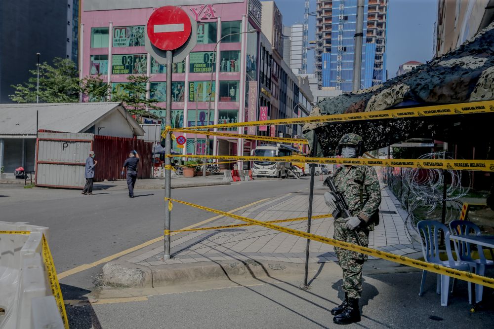 An Armed Forces personnel patrols the vicinity of Menara City One in Kuala Lumpur April 1, 2020. u00e2u20acu201d Picture by Firdaus Latif