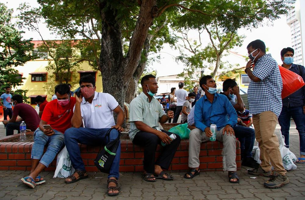 Migrant workers mostly from Bangladesh wear masks as they enjoy a day off on a weekend in Singapore February 23, 2020. u00e2u20acu201d Reuters pic