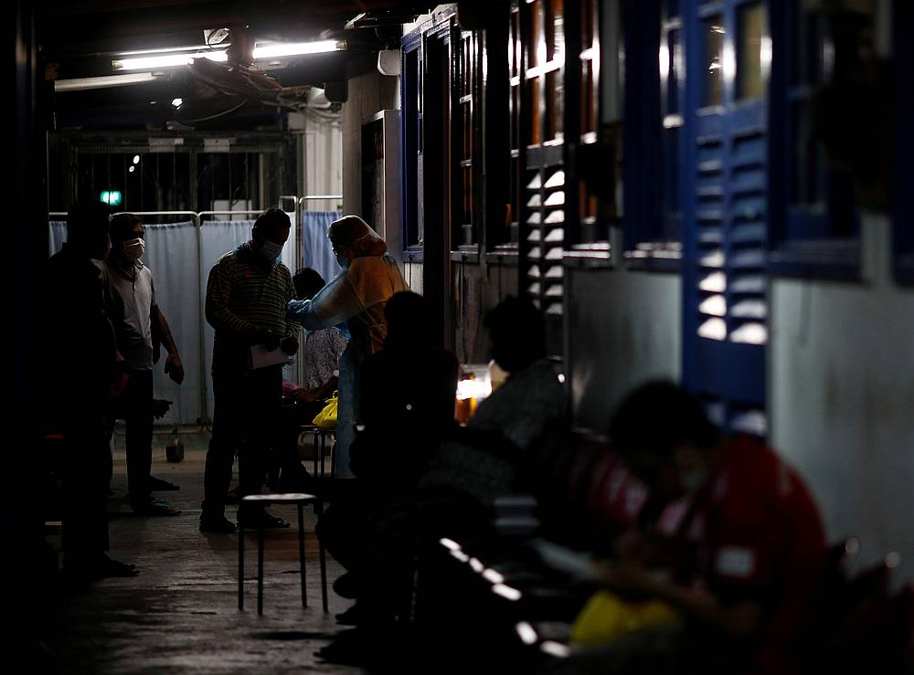 Migrant workers wait to see a doctor at HealthServe clinic, a non-governmental organisation that provides low-cost medical and dental care to migrant workers, in Singapore April 8, 2020. u00e2u20acu201d Reuters pic