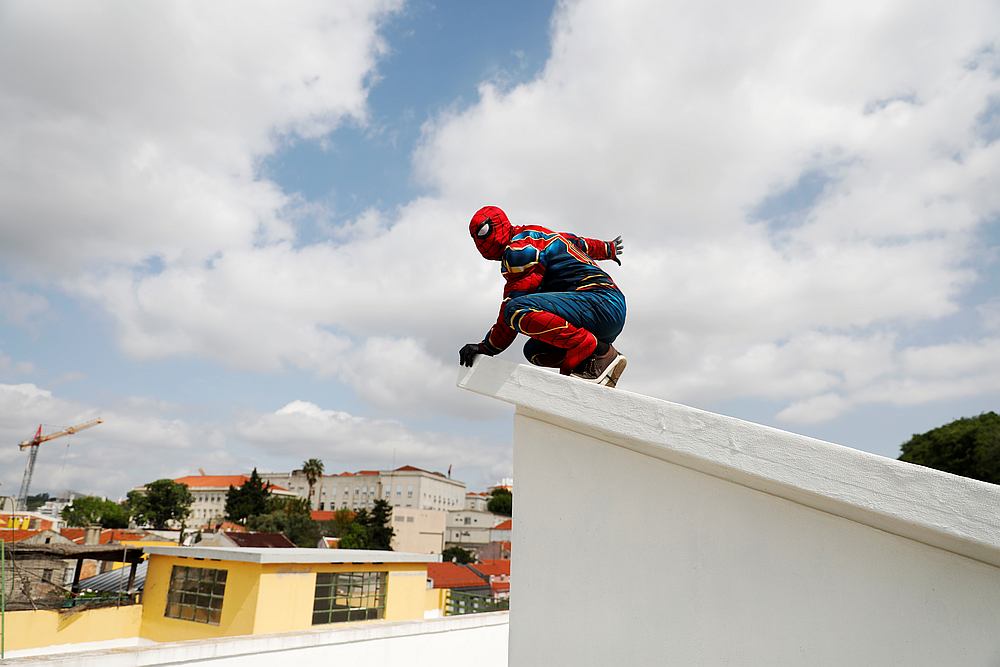Vasco Morgado, president at the Santo Antonio parish council, performs while dressed up as Spiderman during a special tribute to municipal workers in Lisbon, Portugal April 25, 2020. u00e2u20acu201d Reuters pic