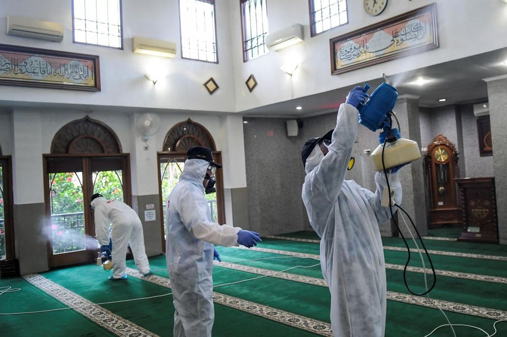 Officials spray disinfectants inside a mosque, after Indonesia confirmed cases of coronavirus disease, in Jakarta, Indonesia, March 8, 2020. u00e2u20acu201d Antara Foto/Galih Pradipta picture via Reuters