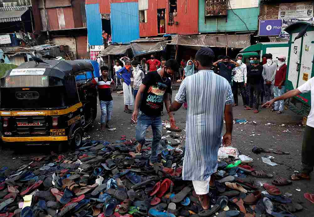 A man walks on scattered footwear after a large crowd of migrants were forced to disperse by police in Mumbai, India April 14, 2020. u00e2u20acu201d Reuters pic