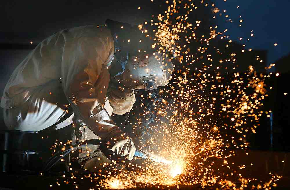 A worker works on a production line at a factory of a ship equipment manufacturer, in Nantong, Jiangsu province, China March 2, 2020. u00e2u20acu201d China Daily pic via Reuters
