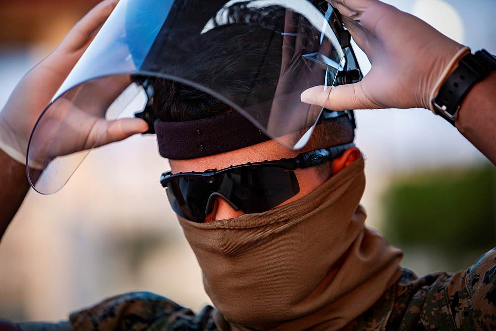 US Marine Corps Pfc. Fernando Luna Simental dons his personal protective equipment to begin screening incoming personnel in response to Covid-19 at Camp Foster, Okinawa, Japan April 10, 2020. u00e2u20acu201d US Marine Corps handout via Reuters 