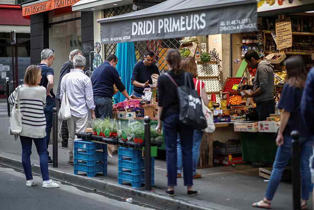 People queue in front of a fruit and vegetables shop at Rue des Martyrs, as the spread of Covid-19 continues in Paris, France April 18, 2020. u00e2u20acu201d Reuters pic