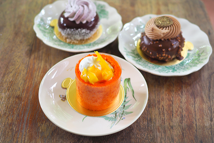 Mango charlotte (front) may have a lurid orange hue but it has a tangy, not too sweet taste, cream cheese blueberry cake (back left) has sponge cake and blueberry layers while the dark chocolate magnum (back right) is a decadent treat with its crunchy chocolate nut studded shell just like the ice cream