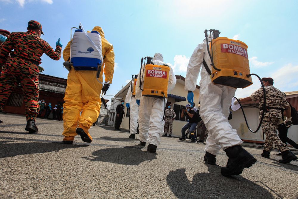 Fire and Rescue Department personnel enter the compound of the Penang Prison for sanitisation work on April 15, 2020. u00e2u20acu201d Picture by Sayuti Zainudin