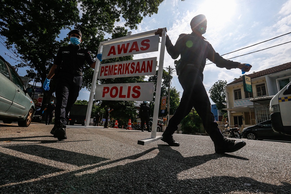 Policemen are seen setting up a roadblock at Jalan Perak in George Town April 14, 2020. u00e2u20acu2022 Picture by Sayuti Zainuddin