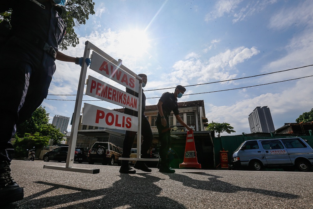 Policemen are seen setting up a roadblock at Jalan Perak in George Town April 14, 2020. u00e2u20acu2022 Picture by Sayuti Zainuddin