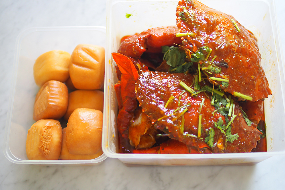 Your chilli crabs and fried mantou are packed in boxes.