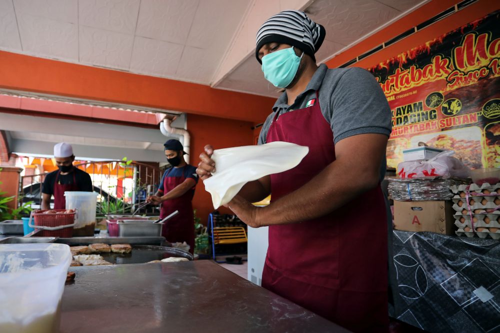 A Ramadan bazaar trader makes u00e2u20acu02dcmurtabaku00e2u20acu2122, Indian-style stuffed pancakes, at his home during the movement control order in Shah Alam April 15, 2020. u00e2u20acu201d Reuters pic