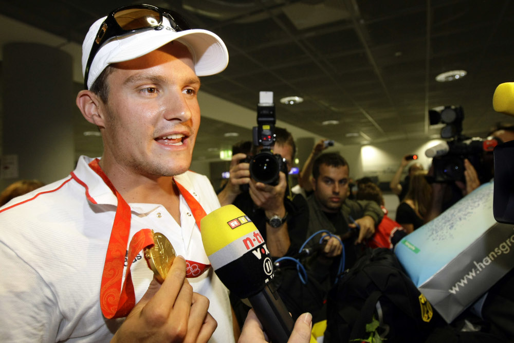 Germanyu00e2u20acu2122s triathlete Jan Frodeno answers reportersu00e2u20acu2122 questions during his arrival at Frankfurt airport August 25, 2008. u00e2u20acu201d Reuters pic