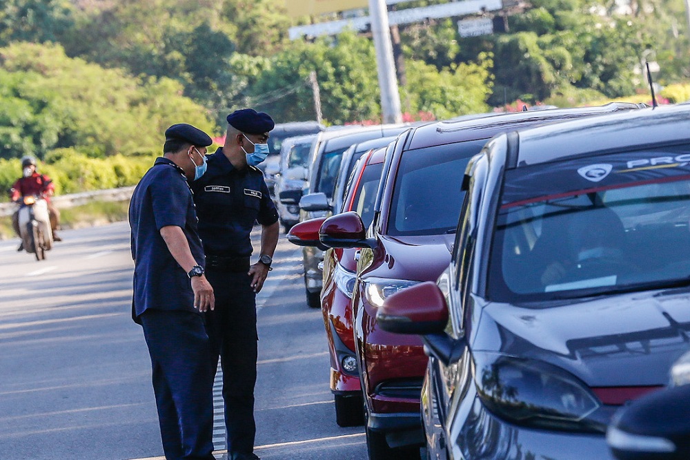 Police personnel man a roadblock at the Jelutong Expressway in George Town April 20, 2020. u00e2u20acu2022 Picture by Sayuti Zainudin
