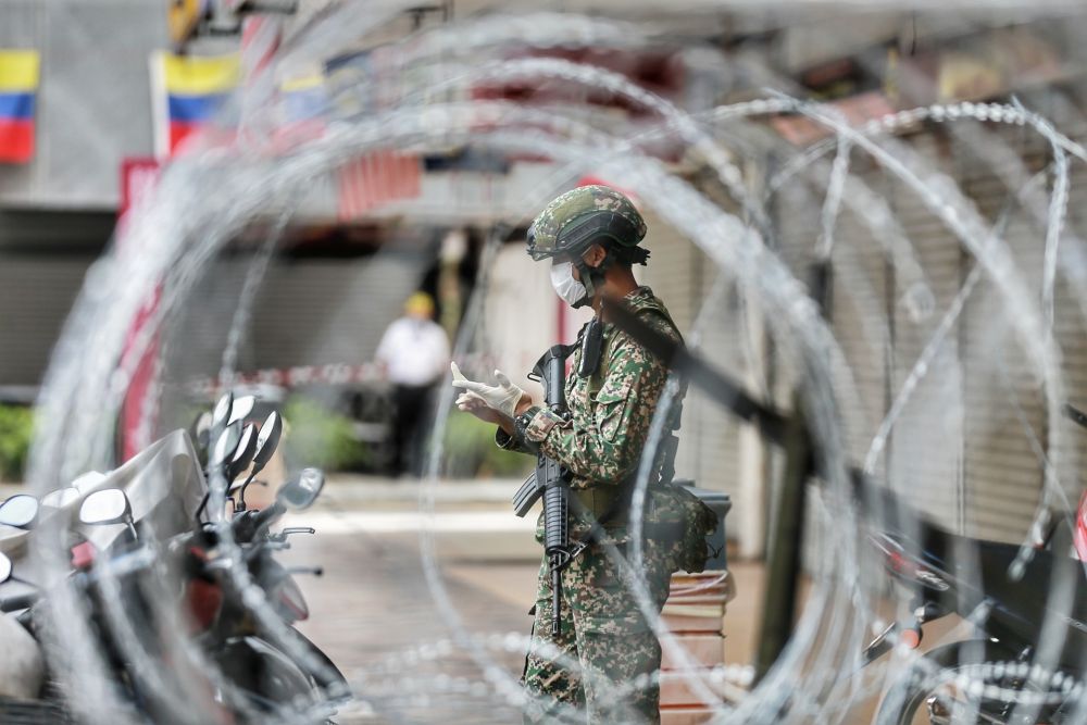 An Armed Force personnel patrols the vicinity of Selangor Mansion, on Jalan Masjid India, April 7, 2020. u00e2u20acu201d Picture by Ahmad Zamzahuri