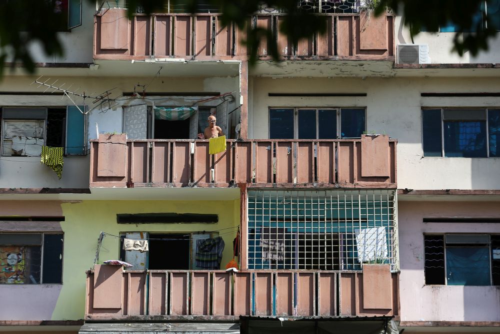 A man is seen at the balcony of his flat unit in Selangor Mansion, Kuala Lumpur April 11, 2020. u00e2u20acu201d Picture by Yusof Mat Isa