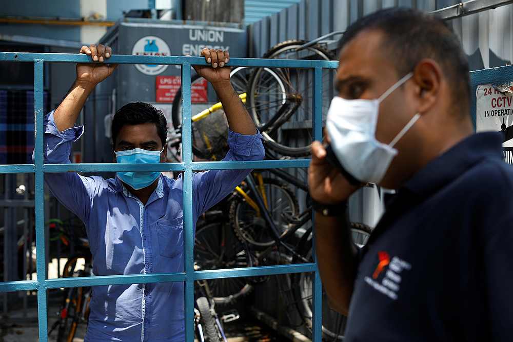 Reverend Samuel Gift Stephen calls his food supplier after hearing feedback from a migrant worker about the food delivered to them during the Covid-19 outbreak in Singapore April 22, 2020. u00e2u20acu201d Reuters pic