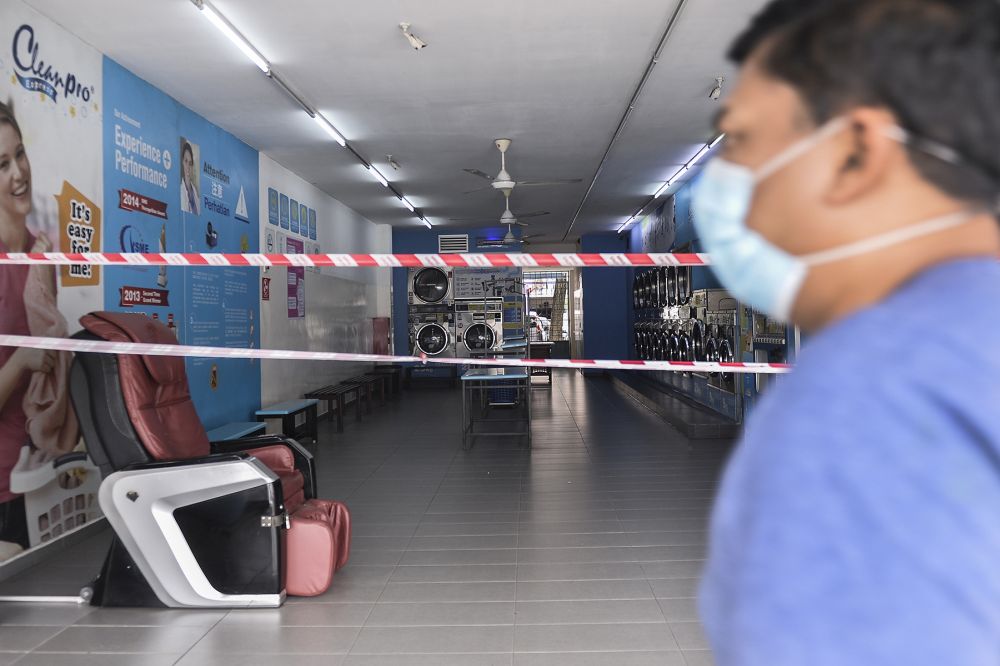 A self-service laundrette in Shah Alam is cordoned off from the public as the movement control order enters phase three on April 15, 2020. u00e2u20acu201d Picture by Miera Zulyana