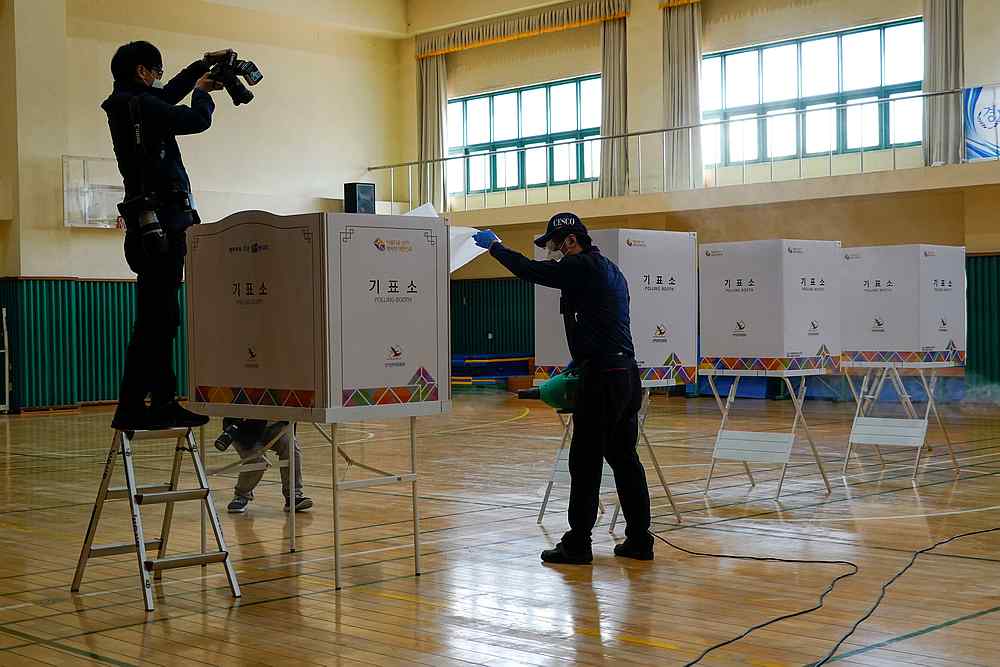 Employees from a disinfection service company sanitise a polling station for upcoming parliamentary election in Seoul, South Korea April 14, 2020. u00e2u20acu201d Reuters pic
