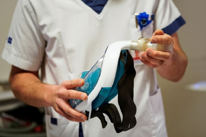 A medical worker shows a Decathlon snorkelling mask, with 3D-printed respiratory valves fittings. u00e2u20acu2022 AFP pic