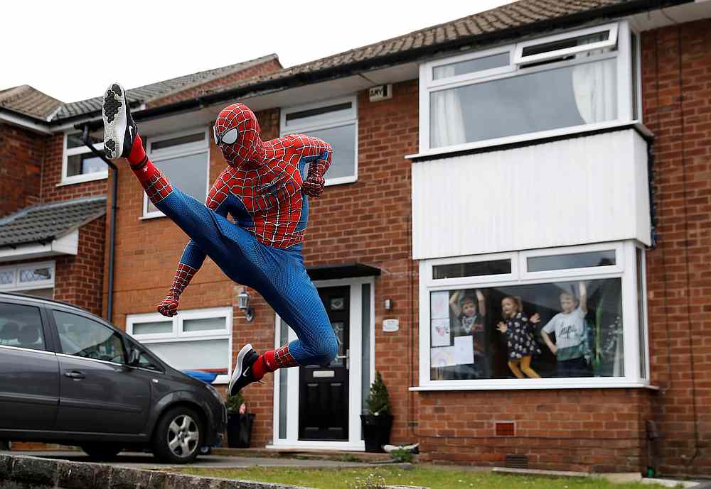 Jason Baird is seen dressed as Spiderman during his daily exercise to cheer up local children in Covid-19 affected Stockport, Britain April 1, 2020. u00e2u20acu201d Reuters pic