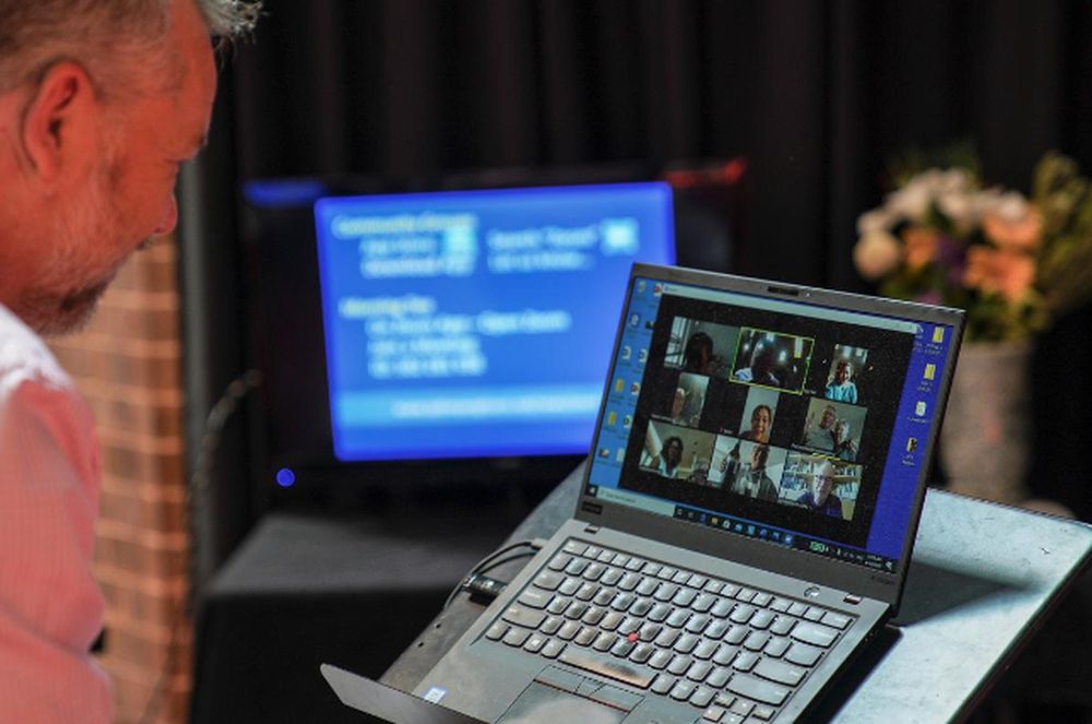 Pastor Matt Johnson interacts with parishioners via Zoom on a laptop upon concluding an Easter service he led which is live-streamed via the internet for the parishioners due to social gathering restrictions to curb the spread of the coronavirus disease, 