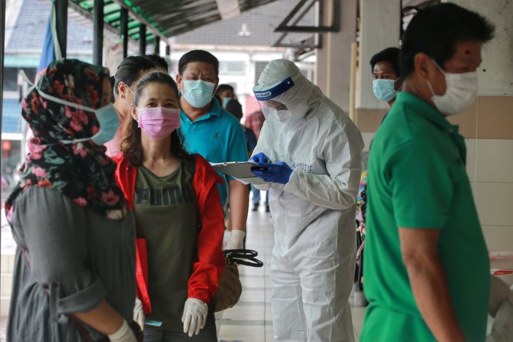 Health workers screen Taman Megah market traders and their workers for Covid-19 in Petaling Jaya April 28, 2020. u00e2u20acu201d Pictures by Ahmad Zamzahuri 