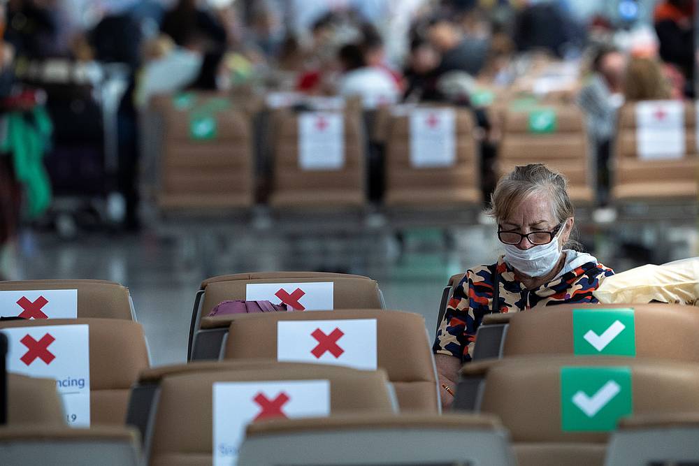 A tourist wearing a protective mask sits on a social distancing seat as she waits for her flight at Bangkok's Suvarnabhumi International airport in Thailand, April 4, 2020. u00e2u20acu201d Reuters pic