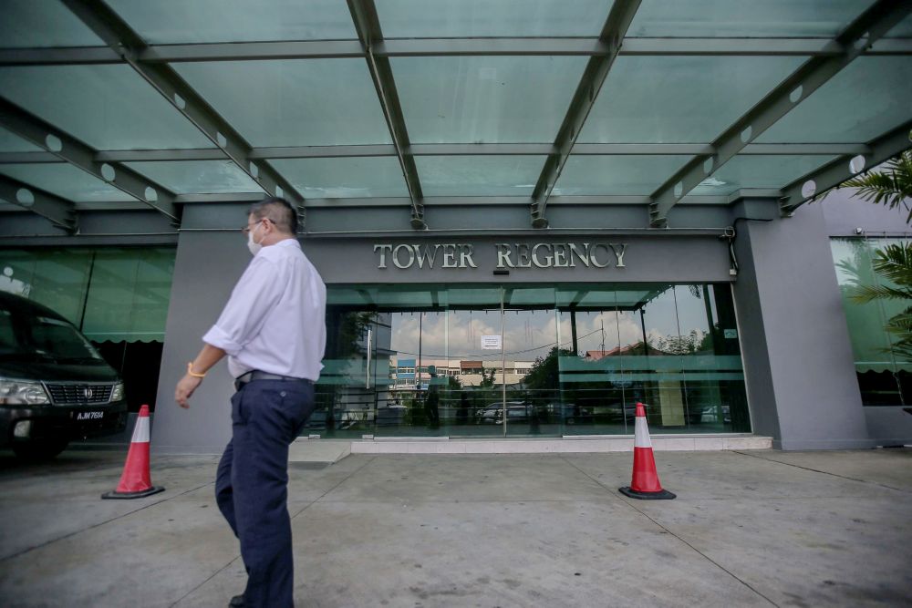 A man walks past the entrance of the Tower Regency Hotel and Apartments in Ipoh, April 1, 2020. u00e2u20acu201d Picture by Farhan Najib