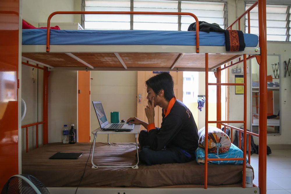 A Universiti Teknologi Mara student studies in his dormitory room during the third phase of the movement control order in Shah Alam April 22, 2020. u00e2u20acu201d Picture by Yusof Mat Isa
