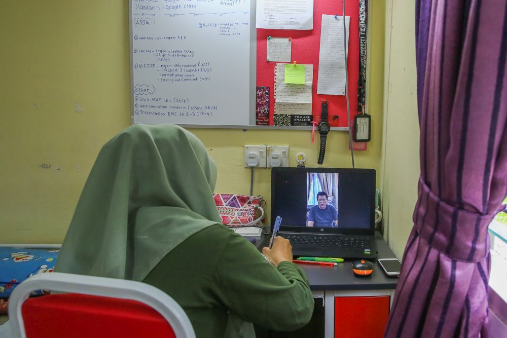 A Universiti Teknologi Mara student takes online lessons in her dormitory room during the third phase of the movement control order in Shah Alam April 22, 2020. u00e2u20acu201d Picture by Yusof Mat Isa