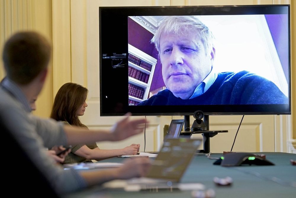 A handout picture released on March 28, 2020, shows an image of Britain's Prime Minister Boris Johnson on a screen as he remotely chairs the morning novel coronavirus meeting by video link, in Downing Street in London. u00e2u20acu201d 10 Downing Street / AFP pic