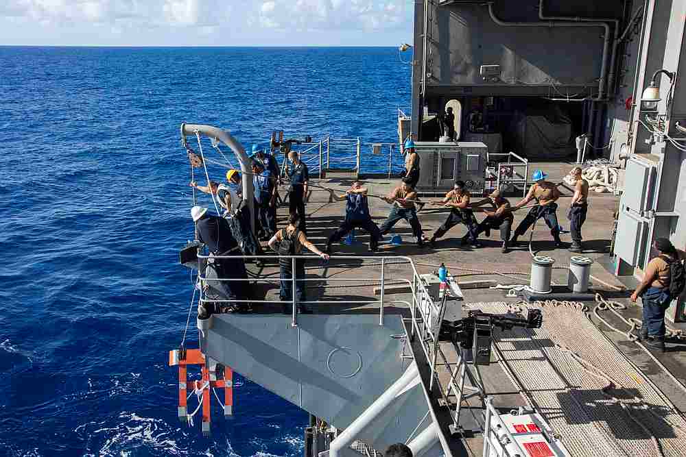 US Navy sailors raise a larne target from the fantail of the aircraft carrier USS Theodore Roosevelt in the Philippine Sea March 21, 2020. u00e2u20acu201d US Navy handout via Reuters 