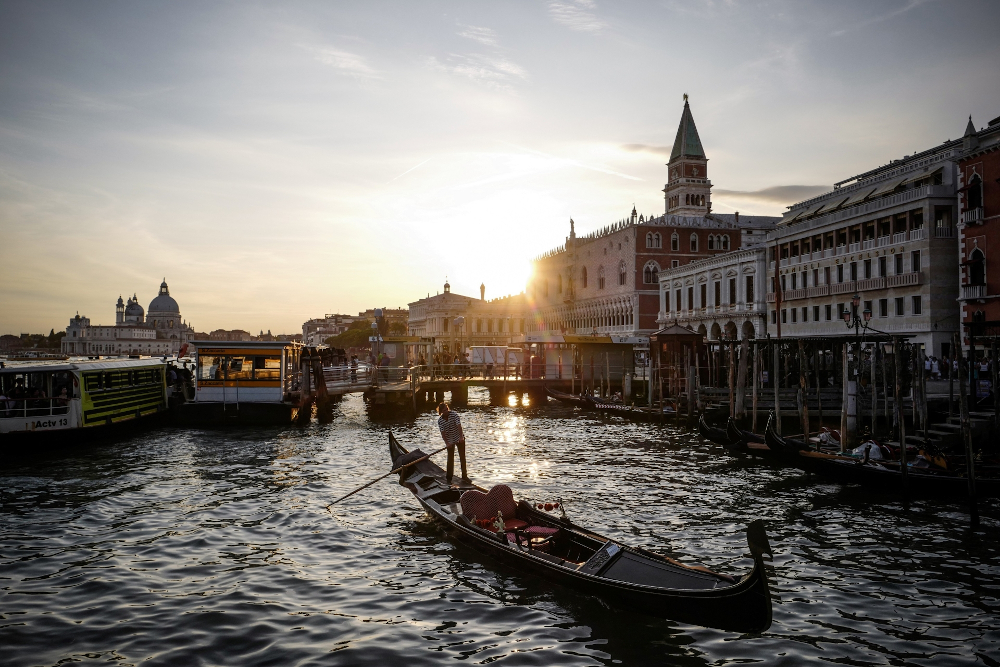 A gondola sails at sunset on the Grand Canal in front of the Palazzo Ducale, Dogeu00e2u20acu2122s Palace in Venice. u00e2u20acu201d AFP pic 