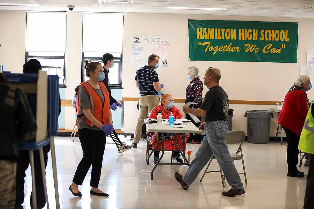 Poll workers stand inside Hamilton High School during the presidential primary election, held amid the Covid-19 outbreak, in Milwaukee, Wisconsin April 7, 2020. u00e2u20acu201d Reuters pic