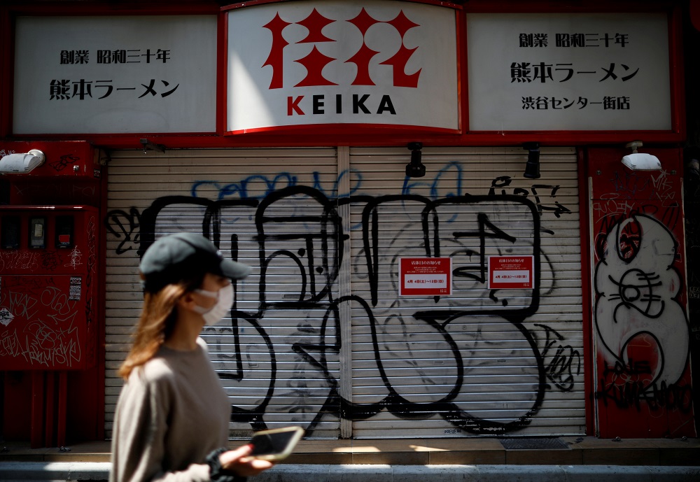 A woman wearing a protective face mask walks in front of a temporary closed ramen noodle restaurant following the disease outbreak in Tokyo April 8, 2020. u00e2u20acu201d Reuters pic