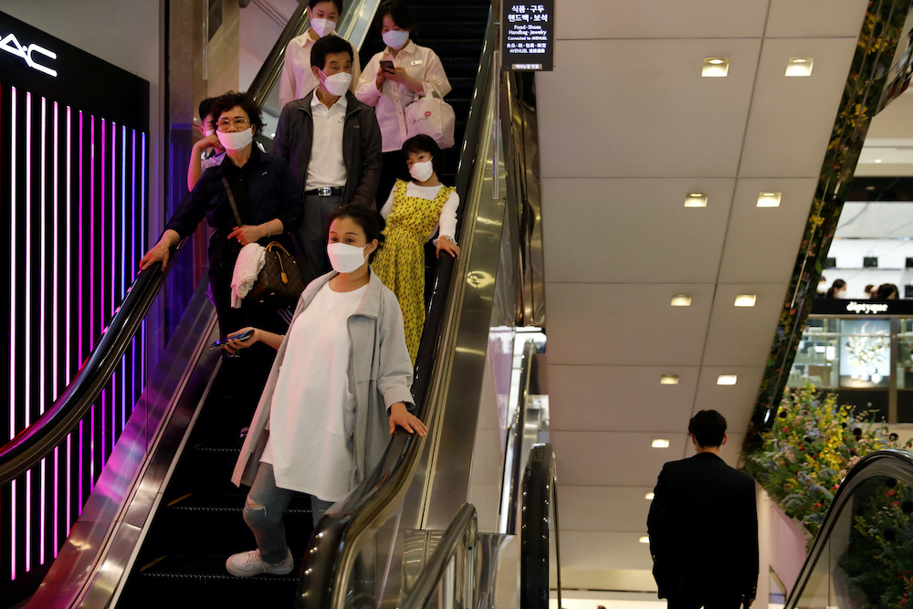 People wearing masks to avoid the spread of the coronavirus disease (Covid-19) ride on an escalator at a department store in Seoul, South Korea, May 1, 2020. u00e2u20acu201d Reuters pic