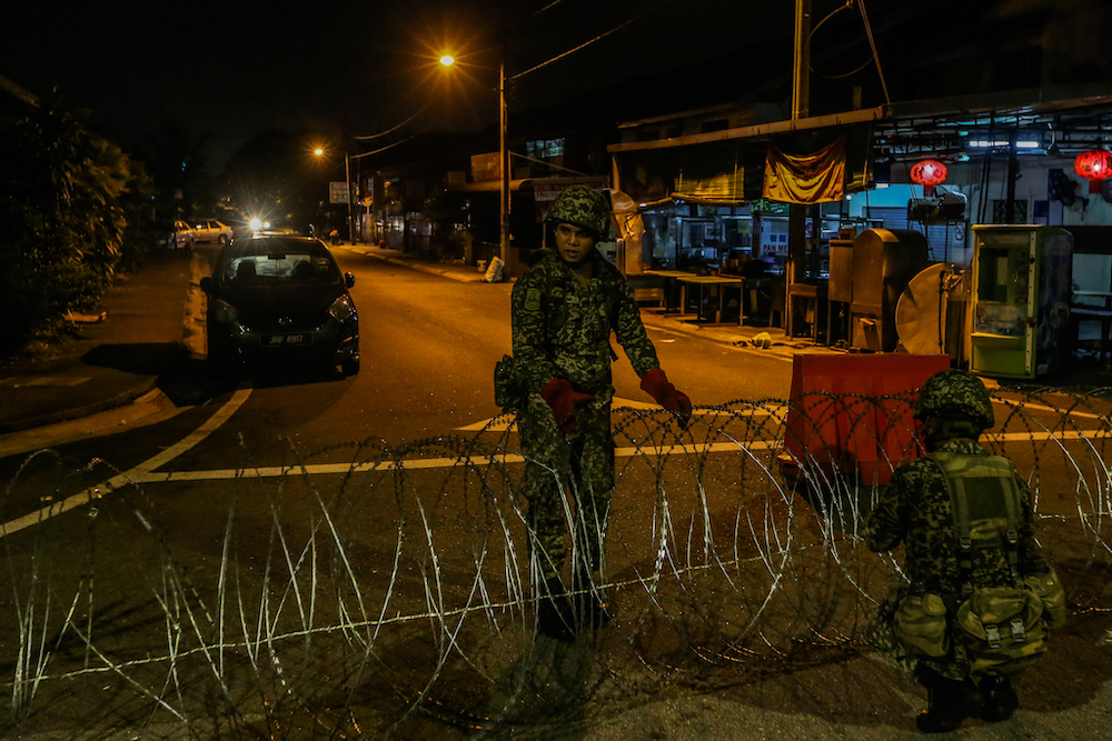 Armed Forces personnel put up barbed wire fencing in Petaling Jaya Old Town that is now under lockdown to curb the spread of Covid-19 May 10, 2020. u00e2u20acu201d Picture by Firdaus Latif