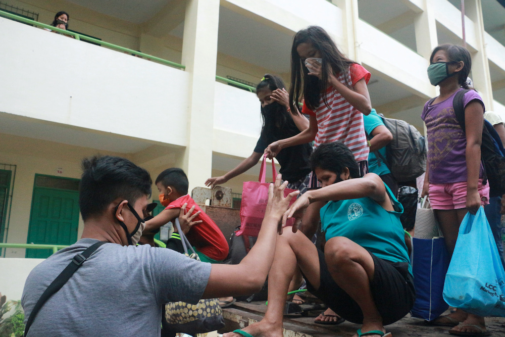 Residents wearing masks for protection against coronavirus disease (Covid-19) arrive at a school turned evacuation center as they prepare for Typhoon Vongfong in Legazpi City, Albay province, Philippines, May 14, 2020. u00e2u20acu201d Reuters pic