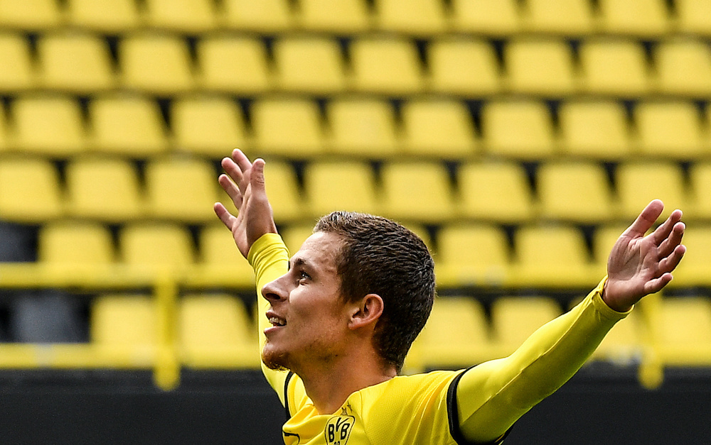 Dortmund's Thorgan Hazard celebrates to the empty tribune after scoring their third goal, as play resumes behind closed doors  in Signal Iduna Park, Dortmund May 16, 2020. u00e2u20acu201d Martin Meissner/Pool via Reuters