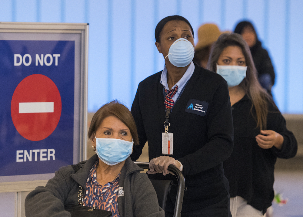 Passengers wear face masks to protect against the Covid-19 after arriving at the LAX airport in Los Angeles. u00e2u20acu201d AFP pic
