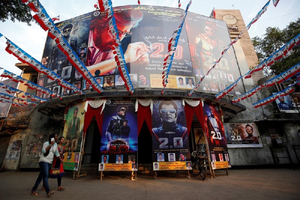 Women walk past a cinema decorated with posters of Tamil film star Rajinikanth's new movie u00e2u20acu02dc2.0u00e2u20acu2122 on the eve of its release, in Mumbai November 28, 2018. u00e2u20acu201d Reuters pic
