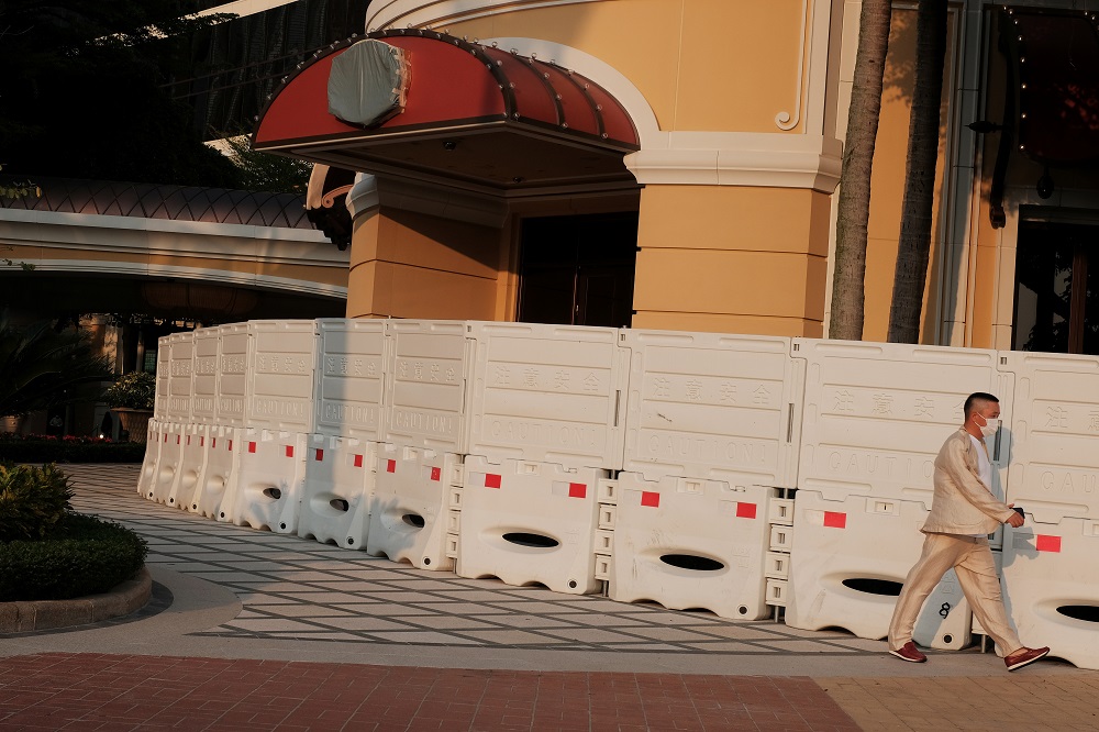 A man wearing a face mask walks past barriers blocking an entrance to the Wynn Macau casino resort, following an outbreak of the novel coronavirus disease in Macau March 24, 2020. u00e2u20acu201d Reuters pic