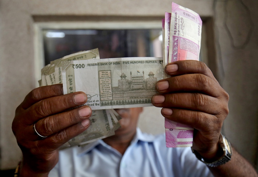 A cashier checks Indian rupee notes inside a room at a fuel station in Ahmedabad September 20, 2018. u00e2u20acu201d Reuters pic