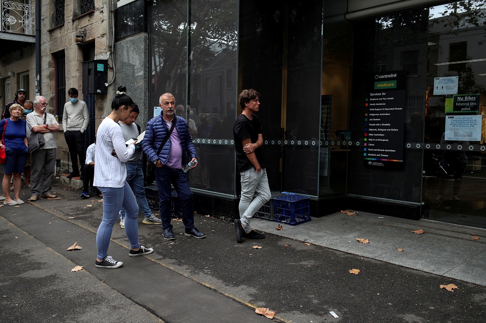 People stand in a queue outside a Centrelink office in Sydney as the spread of coronavirus disease reached what the stateu00e2u20acu2122s premier calls a u00e2u20acu02dccritical stageu00e2u20acu2122 in Australia March 26, 2020. u00e2u20acu201d Reuters pic