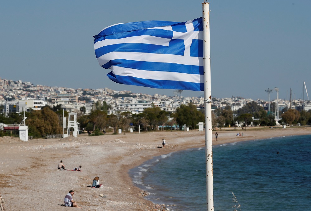 A Greek national flag flutters as people visit a beach, following the coronavirus disease (COVID-19) outbreak, in Athens April 28, 2020. u00e2u20acu201d Reuters pic