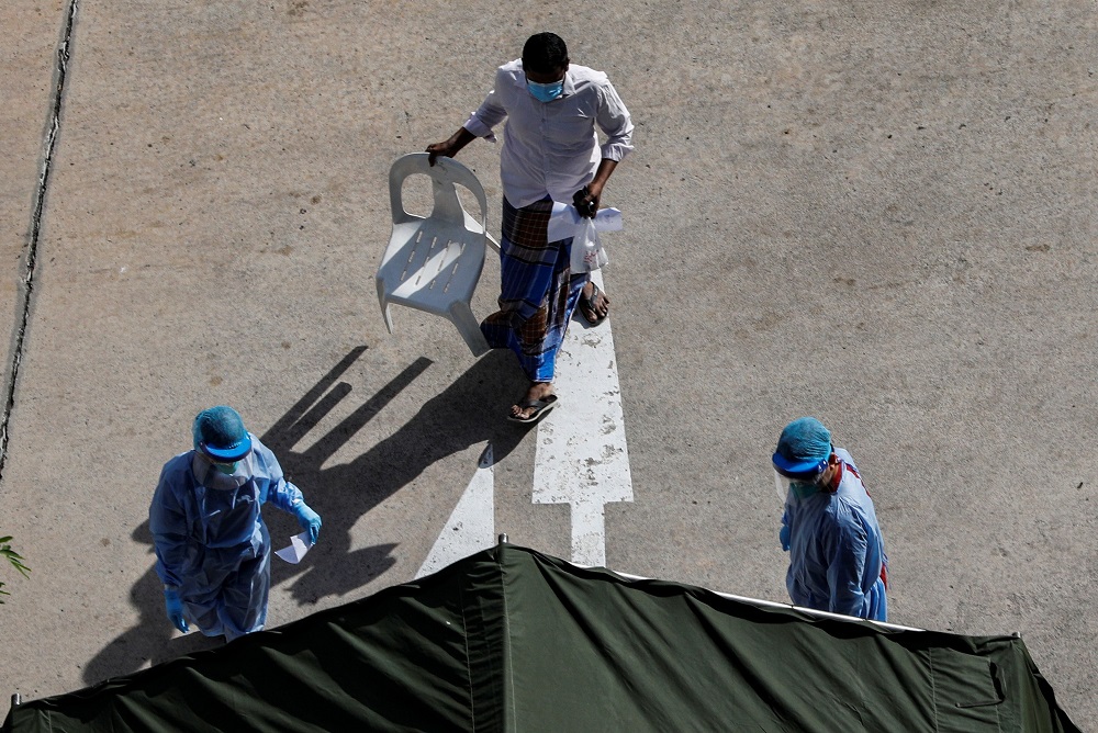 Medical personnel bring a migrant worker into a tent at a dormitory amid the coronavirus disease outbreak in Singapore April 29, 2020. u00e2u20acu201d Reuters pic