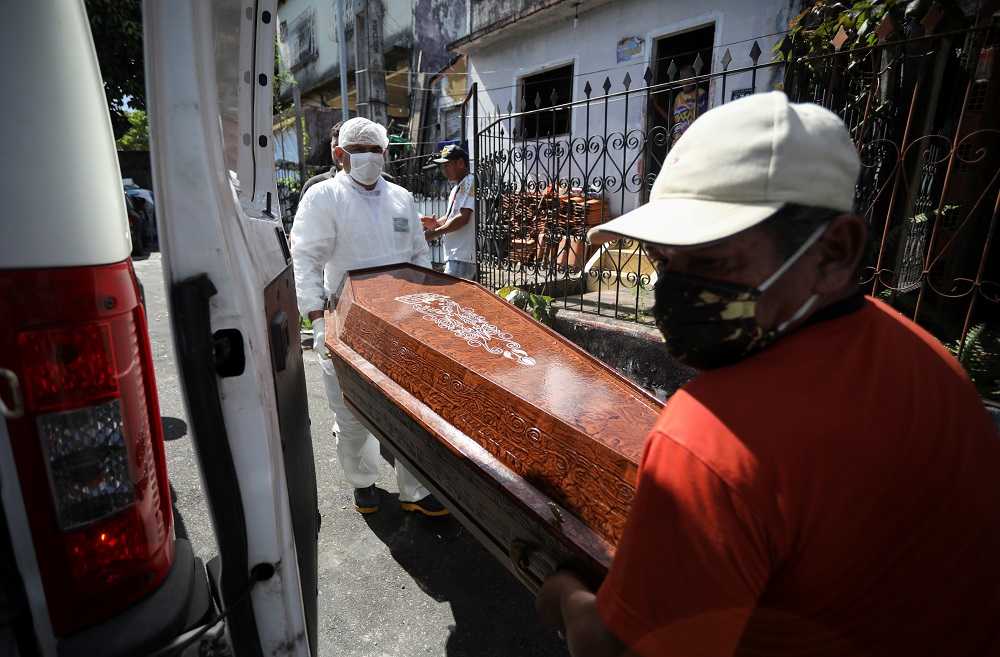 A relative and a worker of the Funeral SOS of the city of Manaus, wearing protective clothing, remove the coffin of a man amid the coronavirus disease outbreak in Manaus, Brazil April 29, 2020. u00e2u20acu201d Reuters pic
