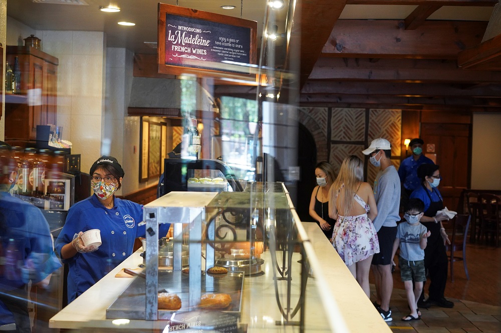 An employee of La Madeleine restaurant wears a mask while attending customers as restaurants are reopened following the lifting of some restrictions in place to prevent the spread of Covid-19 in Houston May 1, 2020. u00e2u20acu201d Reuters pic